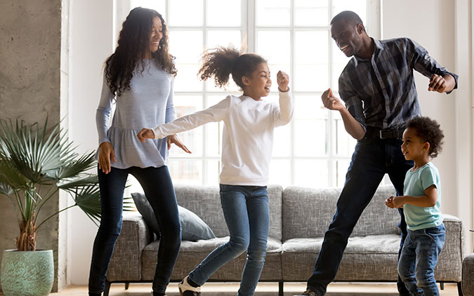 family dancing in living room